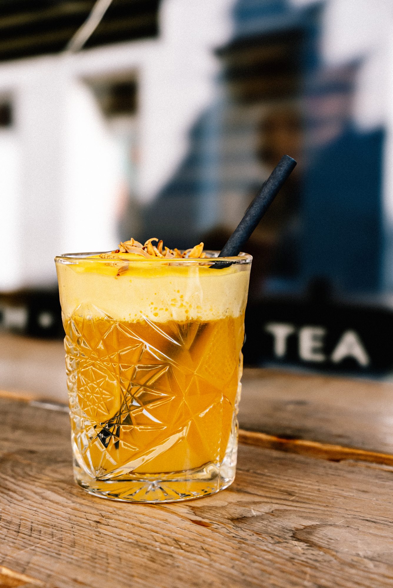 House mango-turmeric drink in a cut-crystal glass.
